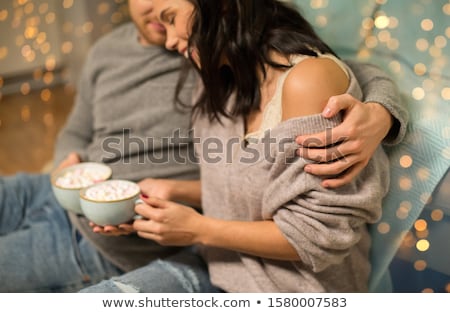 Foto stock: Close Up Of Couple With Hot Chocolate At Home