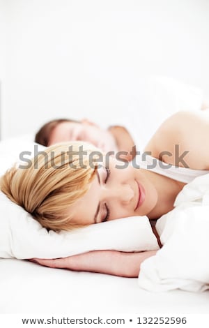 Stok fotoğraf: Closeup Portrait Of A Happy Young Couple Relaxing On The Bed Ma