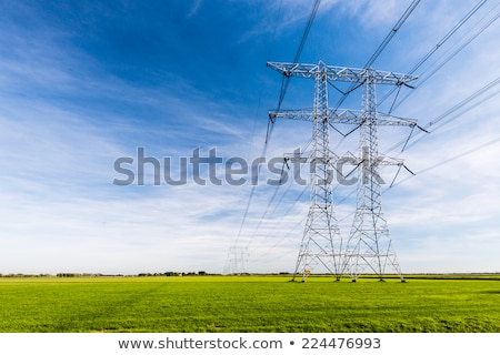 [[stock_photo]]: High Voltage Tower In Rural Landscape With Blue Sky