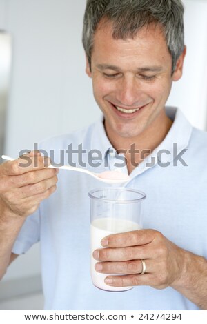 Stock photo: Middle Aged Man Holding Dietary Supplements