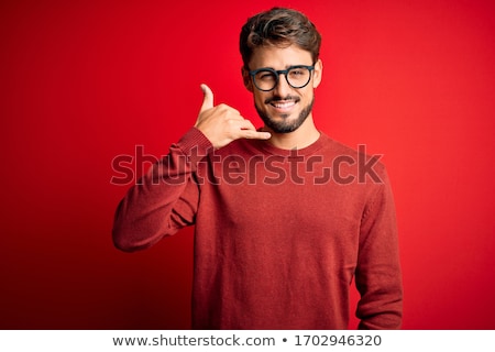Foto stock: Portrait Of A Cheerful Man Standing Over Red Background