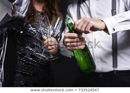 Foto stock: Woman Uncorking Champagne Christmas And New Year