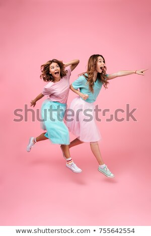 Foto stock: Full Length Of Two Pretty Excited Young Girls Friends