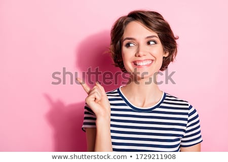 Foto stock: Brunette Girl With Colorful Hair Surprised Looking At Price Of Green Dress