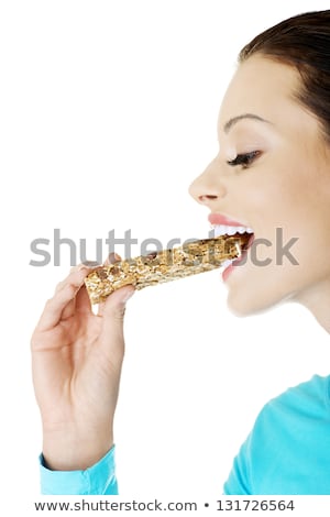 Stock photo: Woman Holding Grain Cereal Bar On White