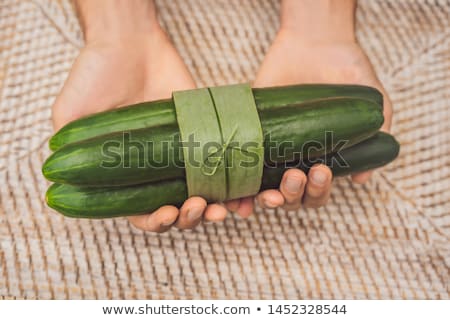 Stockfoto: Eco Friendly Product Packaging Concept Eggplant Wrapped In A Banana Leaf As An Alternative To A Pl