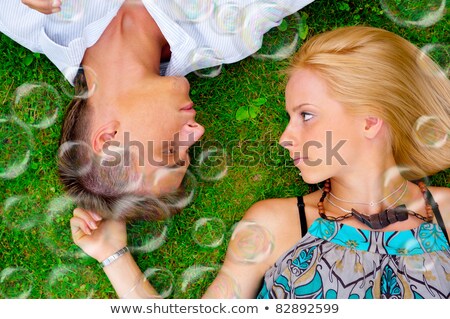 ストックフォト: A Portrait Of A Sweet Couple In Love With Soap Bubbles Around P