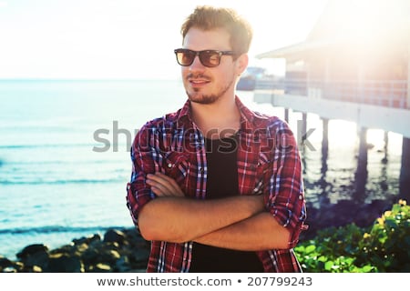 Stock fotó: Handsome Young Man With Plaid Shirt On Blue