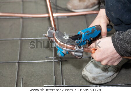 Stock fotó: Man Bending Copper Tubes