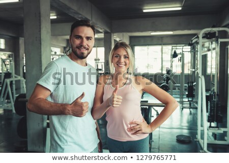 Сток-фото: Portrait Of Happy Young Woman In Sportswear Giving Thumbs Up