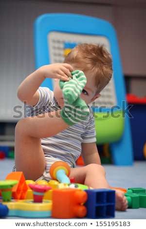 ストックフォト: A Funny Baby Boy Trying To Dress Socks