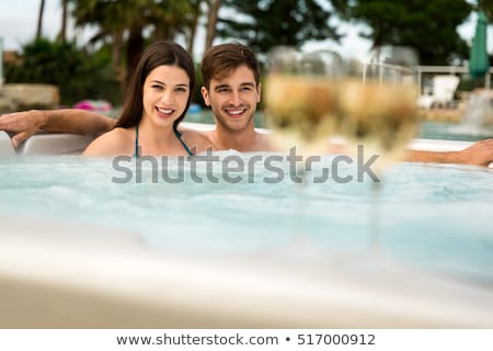 ストックフォト: Young Couple Relaxing In Jacuzzi