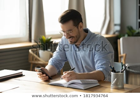 Foto stock: Young Man Considering And Making Notes