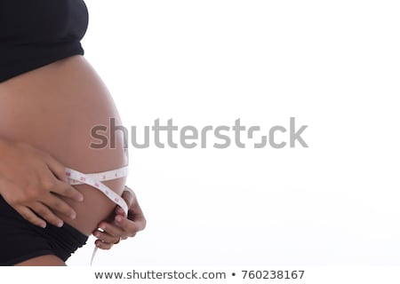 [[stock_photo]]: Woman Abdomen With Measuring Tape Over Black Background