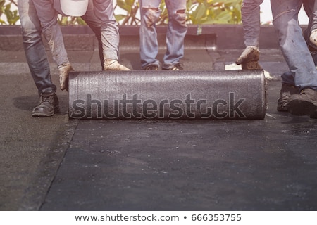 Stock photo: Roofer Installing Bitumen Roof Sheets