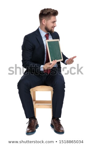 Stok fotoğraf: Proud Seated Man Wearing Elegant Green Suit Looks To Side