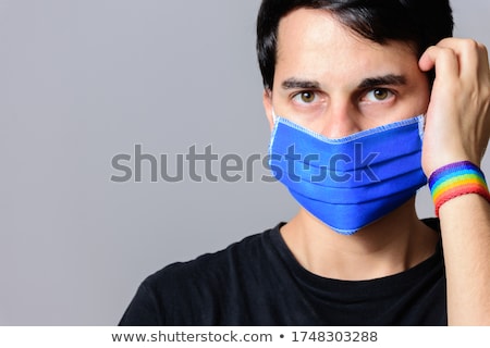 Stok fotoğraf: Man With Gay Pride Rainbow Flag And Wristband