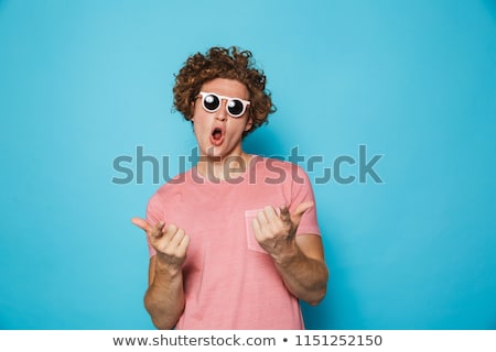 Stock foto: Portrait Of An Excited Young Man With Curly Hair