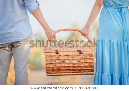 Stockfoto: Couple In Love Walking And Holding A Picnic Basket On Nature Out