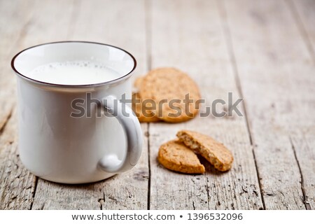 Stock photo: Cup Of Milk And Some Fresh Baked Oat Cookies On Rustic Wooden Ta