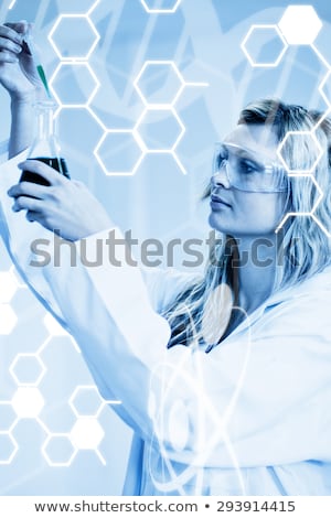 Stock photo: Woman In Lapcoat Looking At Chemicals