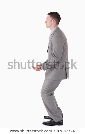 ストックフォト: Portrait Of A Smiling Businessman Carrying Something Against A White Background