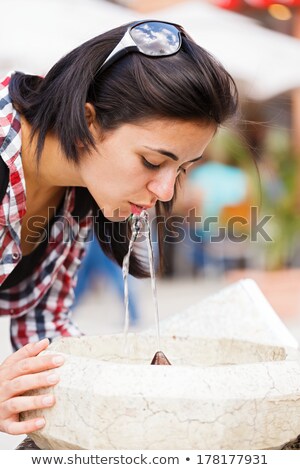 Foto d'archivio: Beautiful Young Woman Drinking Clean Water From Street Fountain