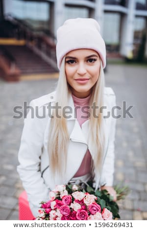 Foto d'archivio: Beautiful Young Woman Holding Pink Rose Isolated