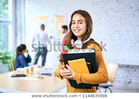 Foto stock: Portrait Of Young Smart Student With Books Standing