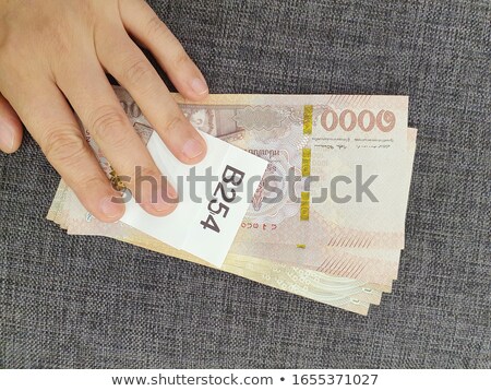 Foto stock: Person Counting Certain Amount Money