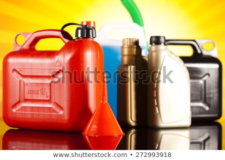 Stockfoto: Canisters Liquids For Car On Vivid Moto Concept