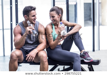 Zdjęcia stock: Woman And Man Sitting On The Bench At Gym