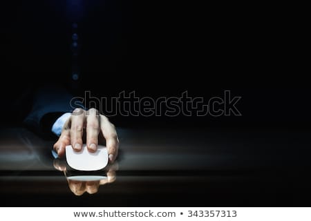 Foto stock: Hand Using Mouse On Dark Background