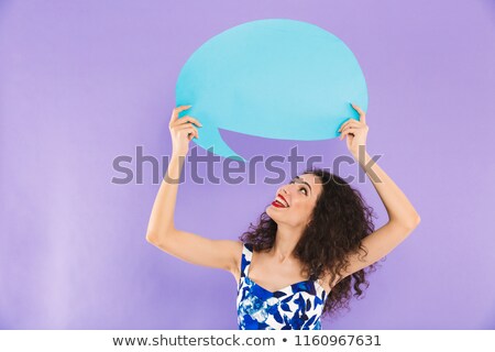 Stock photo: Image Of Adverising Woman With Curly Hair In Dress Smiling And H