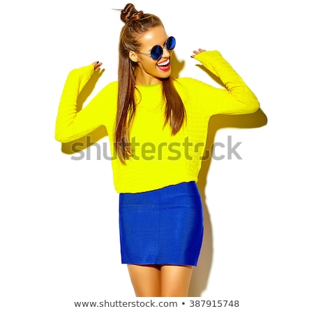 Stok fotoğraf: A Teenage Girl In White Clothes Posing On A Yellow Background The Girl Lowered Her Jacket To Her El