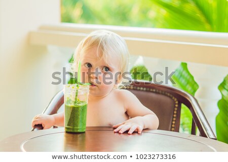 Foto d'archivio: Child Boy Drinking Healthy Green Vegetable Smoothie - Healthy Eating Vegan Vegetarian Organic Foo
