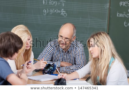 Foto d'archivio: Young Schoolboys Discussing Homework And School Assignments In C