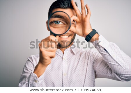 Stock foto: Man Shows Smile Through Magnifier