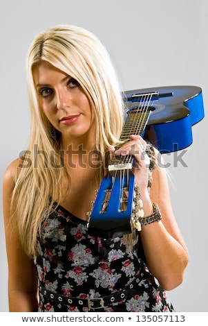 Foto stock: Blond Woman With Guitar Over Her Shoulder