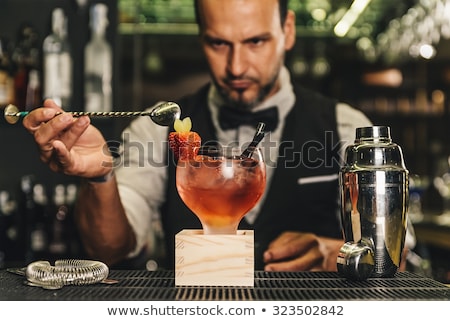 Foto stock: Bartender Is Making Cocktail At Bar Counter At Night Club Toned