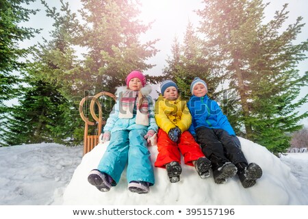 Foto stock: Three Friends Sit On Snow And Throw Snows