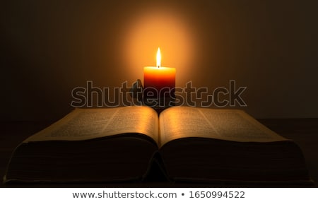 Foto d'archivio: Open Book With Burning Candle