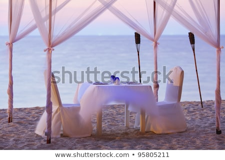 Foto d'archivio: A Good Place For Romantic Dinner On The Beach Long Exposure Sho