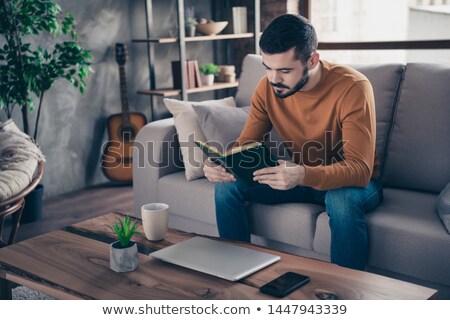 Foto stock: Man Is Looking For Information In The Dictionary