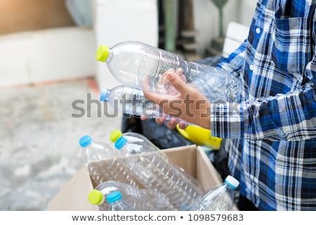 Stock fotó: Young Woman Recycling Empty Plastic Bottles