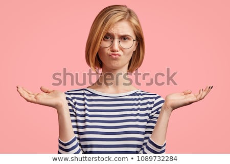 Foto stock: Young Puzzled Woman