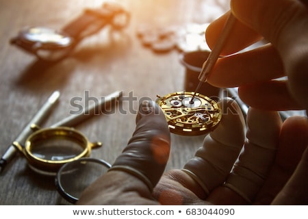 Stock photo: Man Fixing Watch