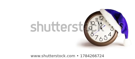 Stock fotó: Santa Claus Hat On New Years Night On The Old Clock Showing Twe