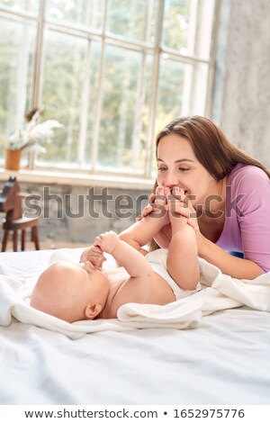 Stockfoto: Mother Kiss Foot Her Newborn Baby