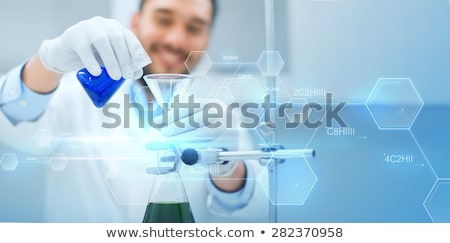 Foto d'archivio: Close Up Of Scientist With Tube Making Test In Lab